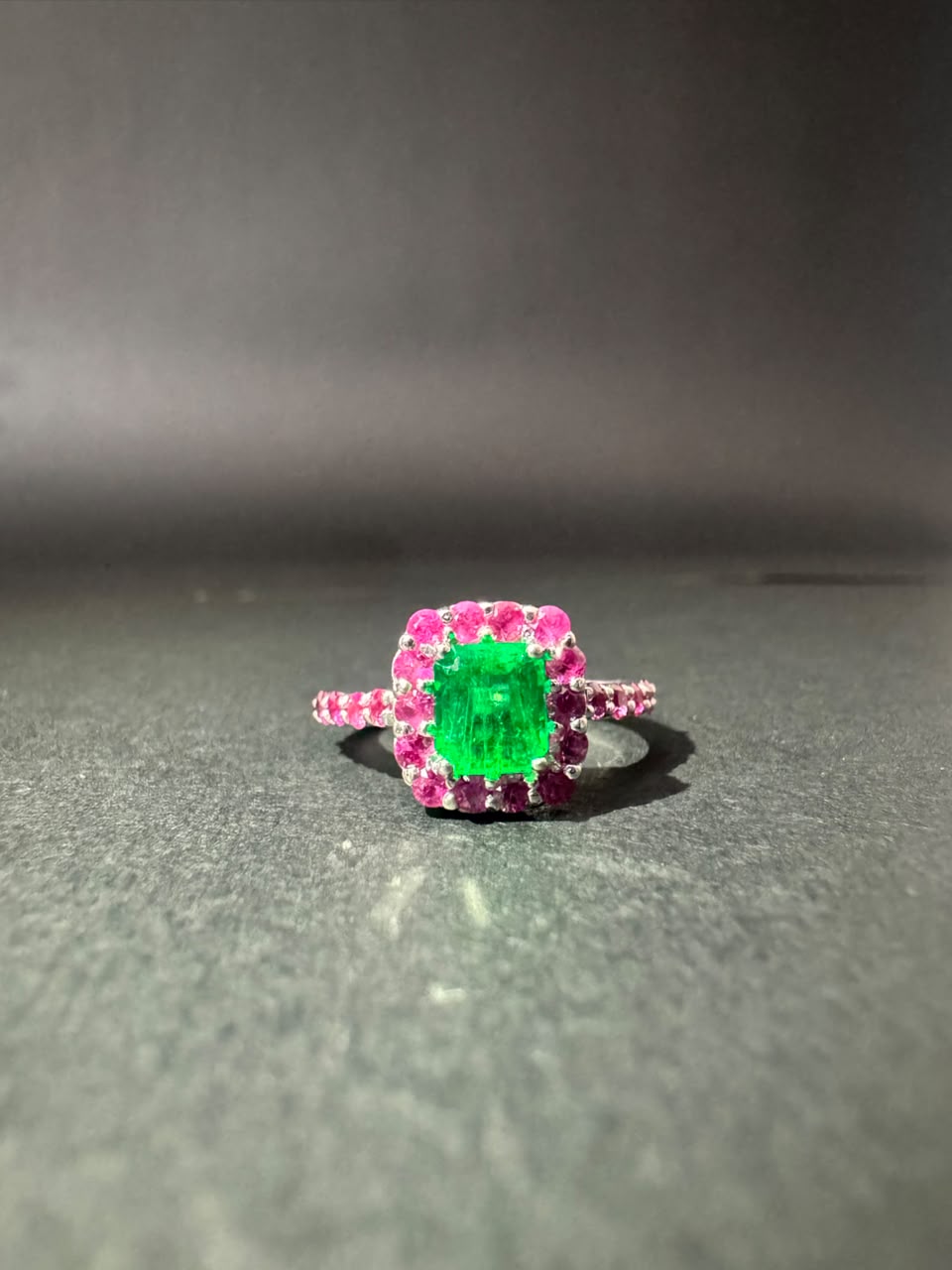 Emerald ring with a pink stone halo (Ref. 179)