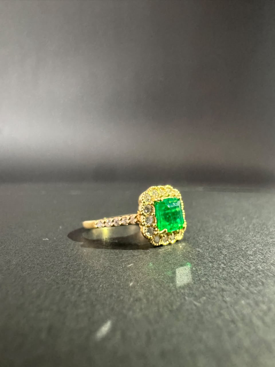 Square emerald ring in a diamond halo (Ref. 291)