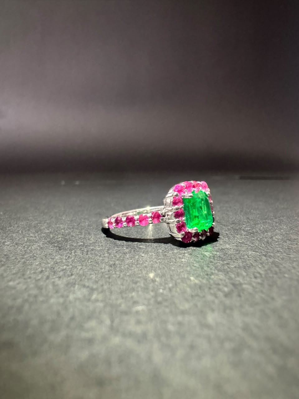 Emerald ring with a pink stone halo (Ref. 179)