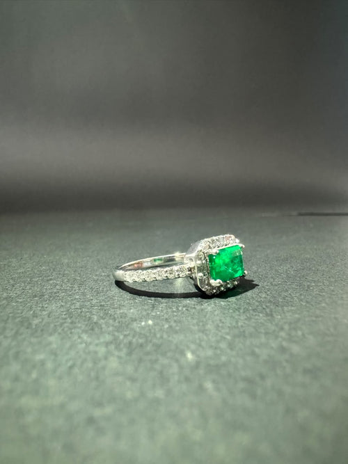 Ring with horizontal rectangular emerald in a halo (Ref. 286)