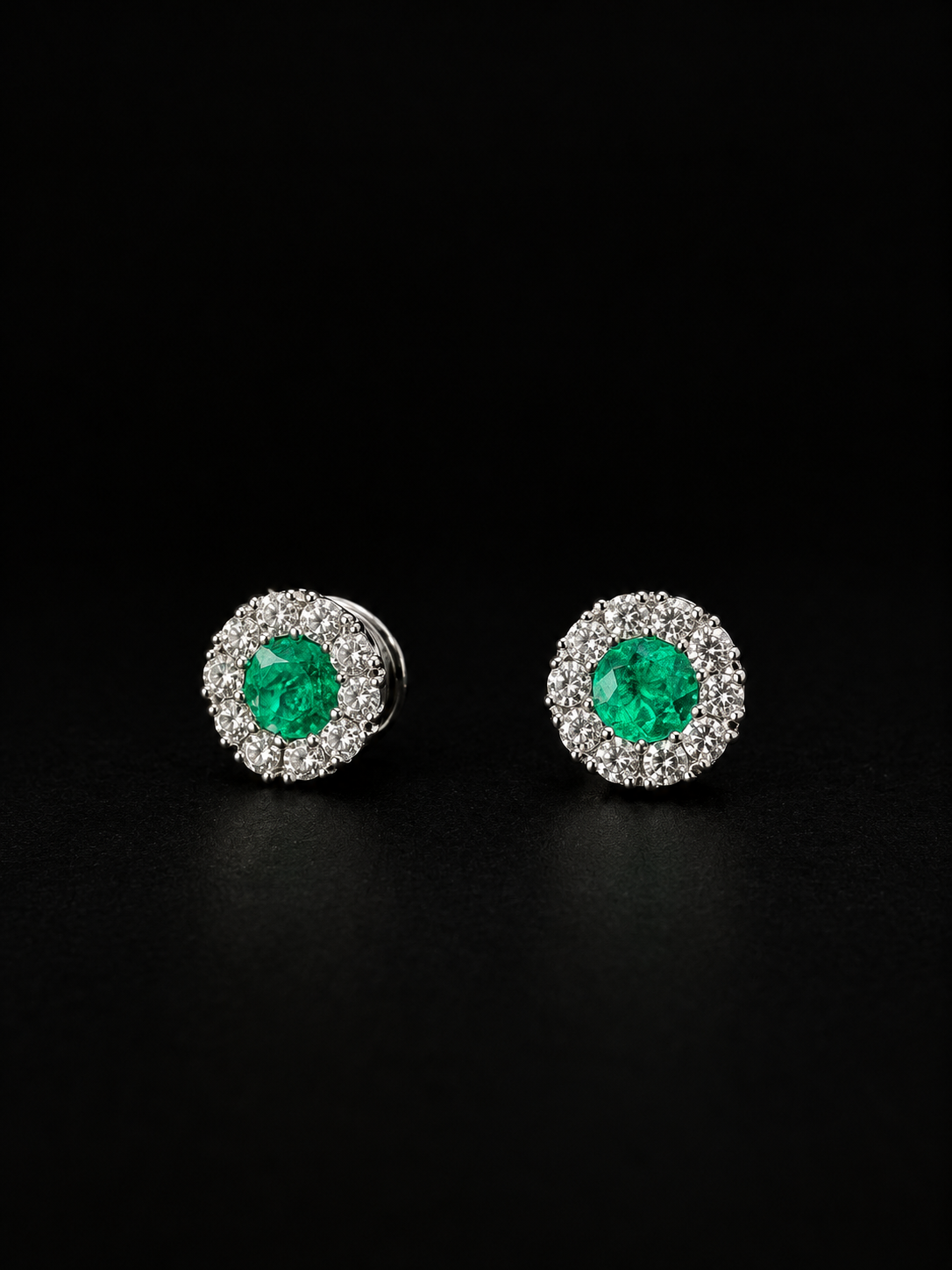Round emerald stud earrings with a diamond halo (Ref. 275)
